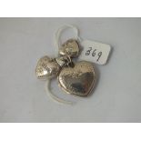 Three silver heart shaped lockets