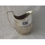 A late Victorian half fluted cream jug, rim foot - 4" high - London 1891 - 135gms