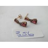 A pair of red stone drop ear pendants in 9ct - 1.5gms