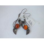 A pair of silver & amber leaf long ear pendants