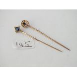 Two antique gold stick pins - 1 design as a horse shoe set with 1/2 pearls & the other a central