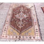 A chocolate coloured rug with center madellion - 5'6 x 3'6"