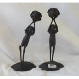 A pair of bronze figure candlesticks. 9.5" high.