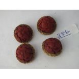 Four cinnabar floral domed buttons