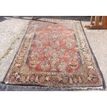 A red ground kashan rug with blue border (moth!) - 7' x 4'