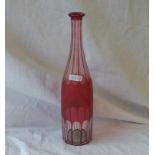 A cranberry glass decanter with cut decoration. 13" high