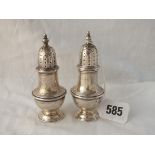 A pair of Georgian style peppers with urn phinials - 4" high - B'ham 1926/7 - 86gms