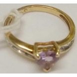 AN AMETHYST HEART SHAPED RING WITH DIAMOND SHOULDERS IN 10ct