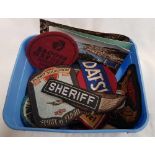TUB WITH VARIOUS CLOTH SHOULDER BADGES, SUZUKI, SHERIFF HOLIDAY TRAVEL