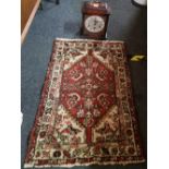 MAHOGANY CASES CHIMING PENDULUM CLOCK & SMALL RED CROWNED PATTERN RUG 33'' X 22''