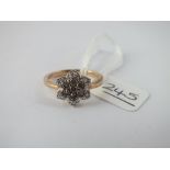 A diamond cluster dress ring in 9ct - size K - 3gms