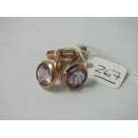 A pair of purple stone cufflinks in 9ct - 8.1gms