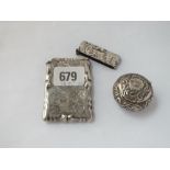 An Edwardian scroll engraved card case and a pill box with hinged cover