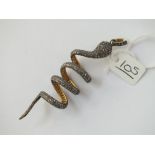 AN UNUSUAL DIAMOND SET SNAKE PENDANT WITH RED STONE EYES SET IN SILVER & GOLD BACK