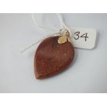 A gold stone heart shaped drop pendant with gold mounts & bale