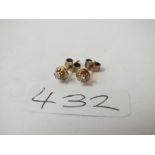 A pair of diamond ear studs in 9ct