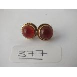 A pair of circular earrings with orange stones in 9ct - 3.2gms