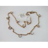 AN EDWARDIAN GOLD MOONSTONE BEAD NECK CHAIN SET IN GOLD - 12.6gms