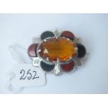 A Scottish silver half stone brooch with central cornelian