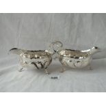 A pair of Chester silver sauce boats, each on three legs - marks rubbed - 1900 - 321gms