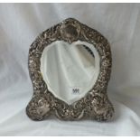 A heart shaped dressing table mirror embossed and pierced - easel backed - 11" high - 1892
