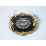 A large antique black enamel, pearl & hair set mourning brooch