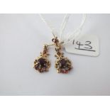 A pair of garnet drop earrings in 9ct