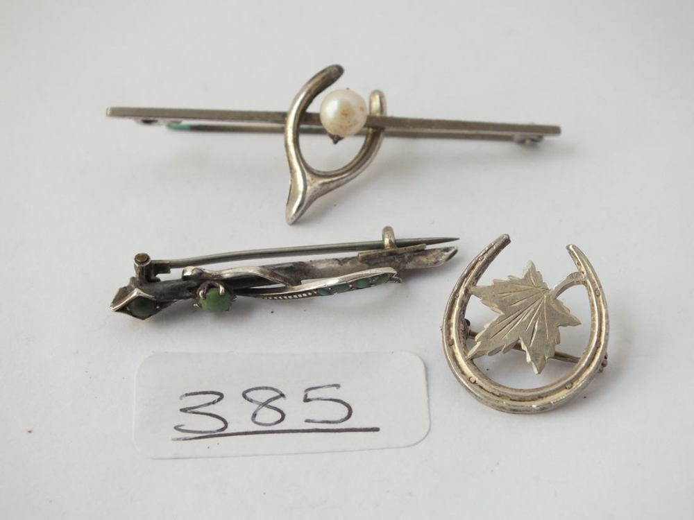 Three silver brooches, green stone/pearl etc.