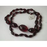 A string of red amber type beads