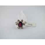 A large garnet central stone & diamond cluster ring set in 9ct - size 0 - 2.9gms