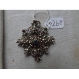 An antique Georgian silver, gold & paste pendant with small central blue stone