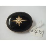 A c19 pearl-mounted onyx mourning brooch
