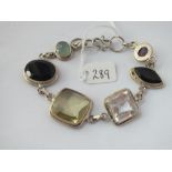 A silver stone set panel bracelet