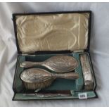 A boxed set of dressing table brushes and mirror with laurel decoration - B'ham 1909