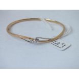 A HINGE OPENING TWO COLOUR GOLD BANGLE WITH DIAMONDS IN 9CT - 10gms