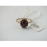 A garnet cluster ring in 9ct - size S