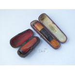 Two amber cigar holders - both in cases