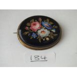 An antique oval painted flower brooch