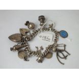 A quality vintage silver charm bracelet incl. a vintage tassel charm & a heart locket charm - 45.