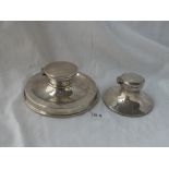 Two capstan-shaped inkwells with hinged covers. One London 1927