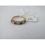 A diamond & ruby 7 stone ring set in 18ct gold - size O - 3.4gms