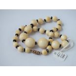 A graduated bone bead necklace