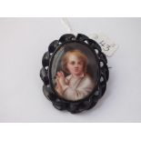 An oval portrait panel brooch in carved jet frame