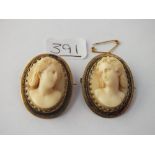 A pair of gilt framed cameo brooches