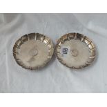 A pair of small strawberry dishes with ribbed sides and centre inset with sixpence dated 1696 and