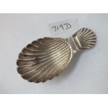 A shell-shaped caddy spoon (unmarked)