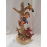 HUMMEL FIGURE OF A DOG CHASING A BOY UP A TREE NO. 56A