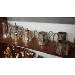 SHELF OF PLATED COFFEE POTS & TEA POTS ETC