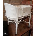 WHITE PAINTED LOOM & CANE BABY COT ON WHEELS