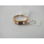 A five stone pearl and garnet ring in 18 ct gold - Size R - 2.8gms.